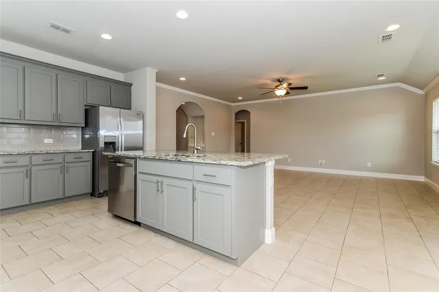 a kitchen with a sink cabinets and appliances