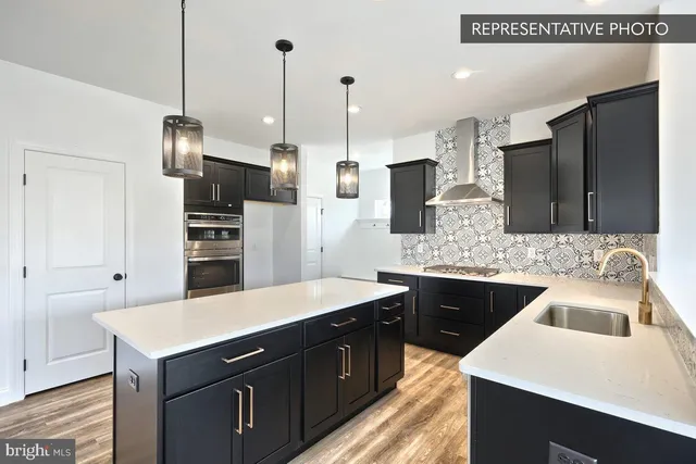 a kitchen with a sink a kitchen island and stainless steel appliances