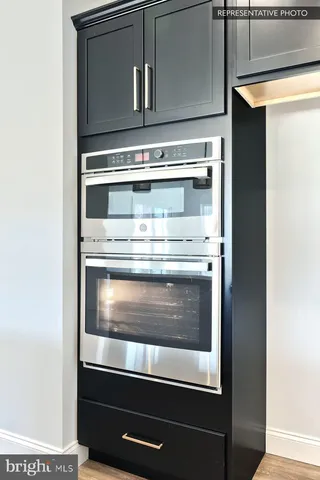 a stove top oven sitting inside of a kitchen