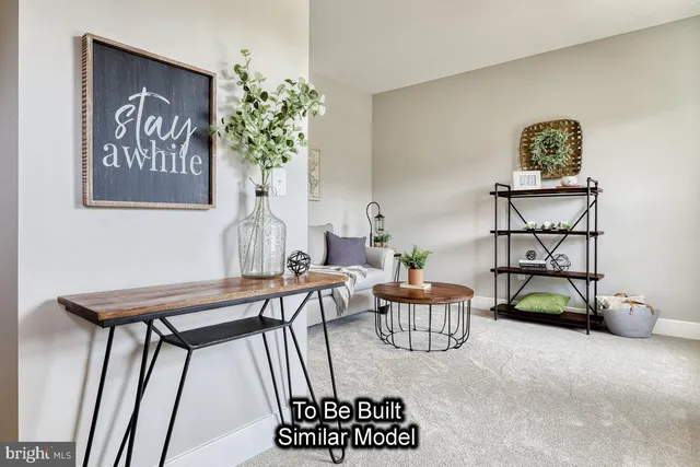 a reading room with furniture and a potted plant