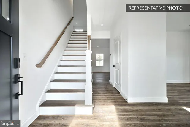 a view of an entryway with wooden floor