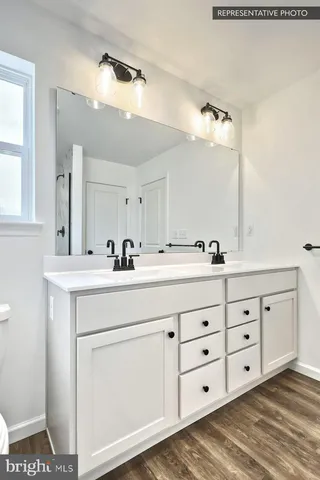 a bathroom with double sink and a mirror