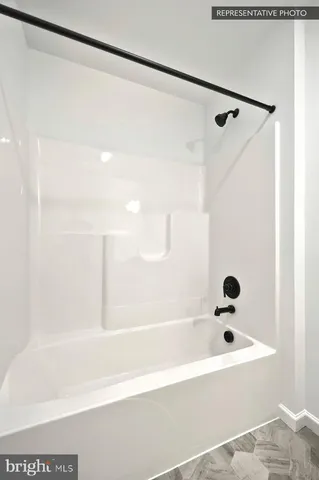 a bathroom with a shower and a bath tub