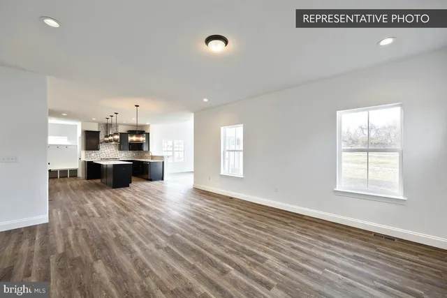 a view of a kitchen with microwave and stainless steel appliances