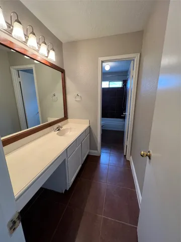 a bathroom with a double vanity sink and mirror