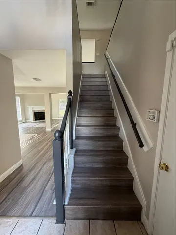 a view of entryway and hall with wooden floor