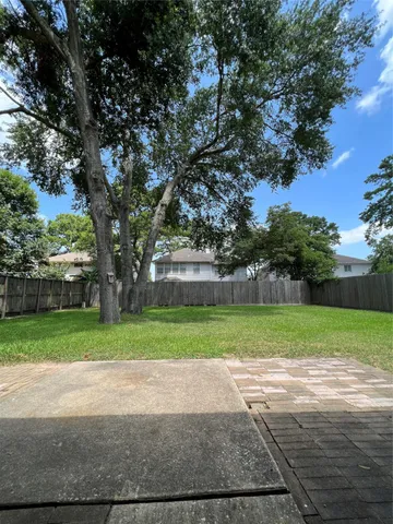 a green field with lots of trees