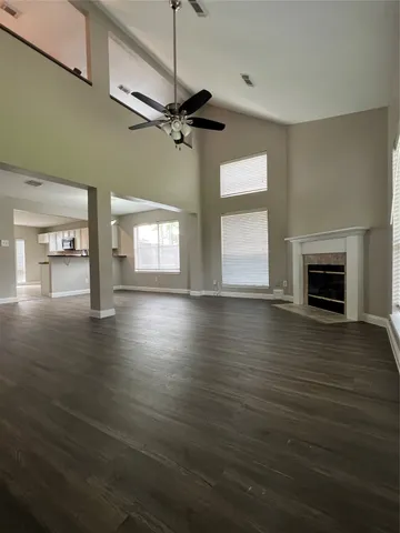 a view of empty room with wooden floor and fireplace