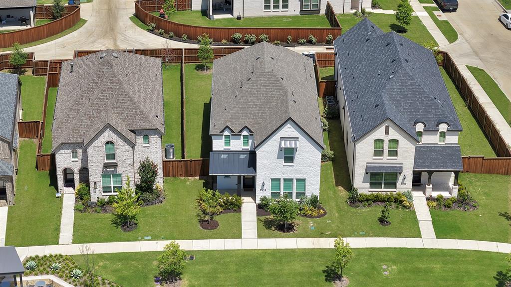 5012 Triadic Lane Prosper, TX 75078 - Photo 4 of 38 Contemporary two-story residence featuring light-colored brick facade and a dark shingle roof