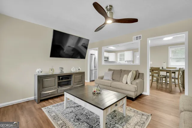 a living room with furniture a flat screen tv and a fireplace