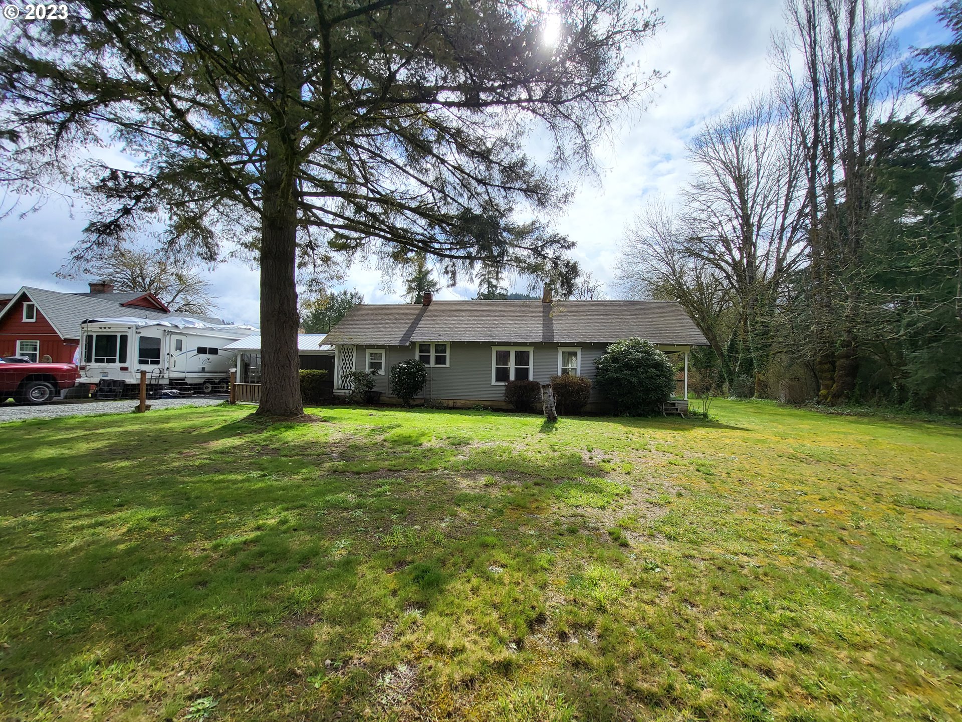 1001 Curtin Road Cottage Grove, OR 97424 - Photo 1 of 24 a front view of a house with a yard and trees