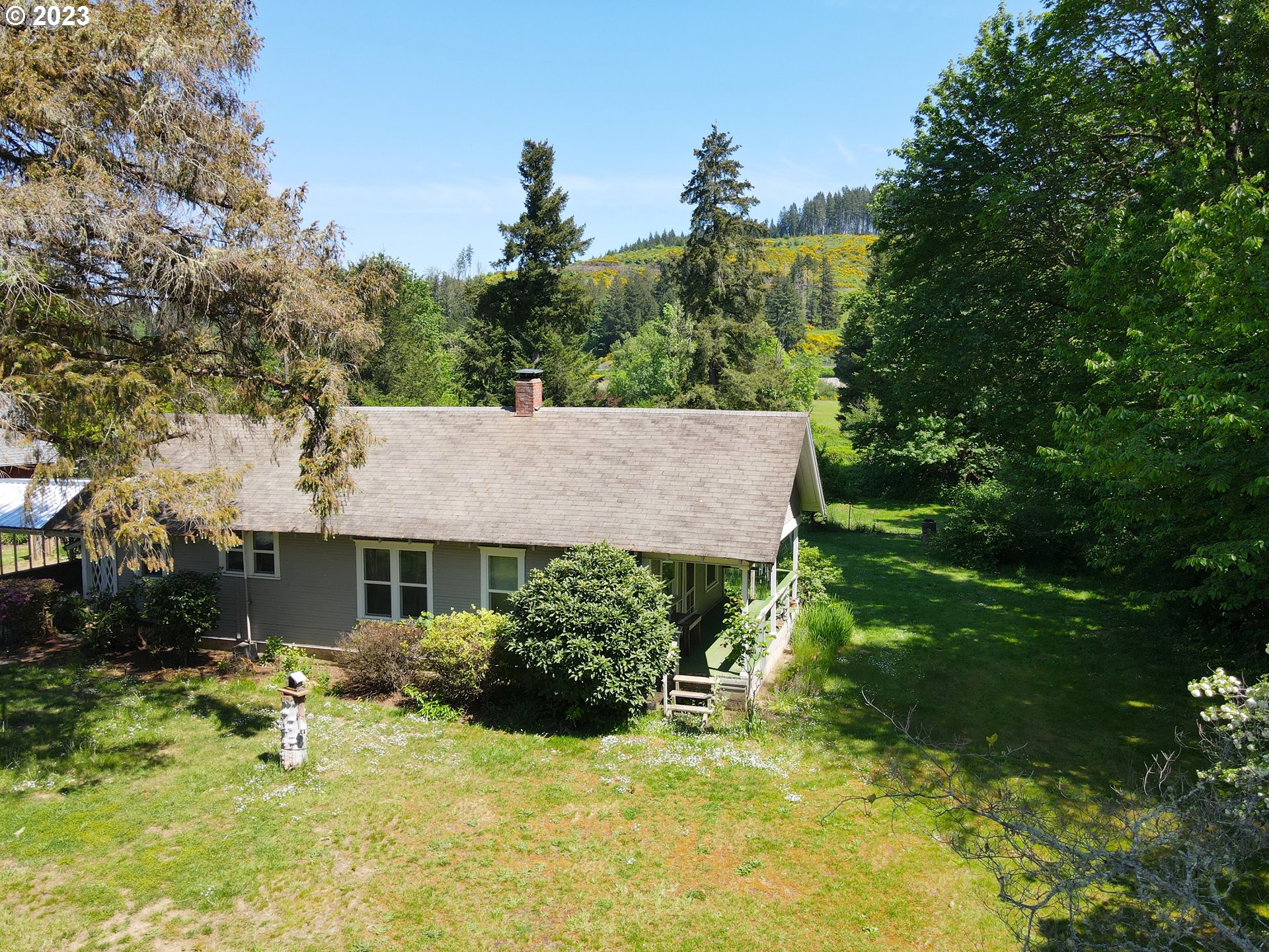 1001 Curtin Road Cottage Grove, OR 97424 - Photo 21 of 24 a view of a house with a yard and tree s