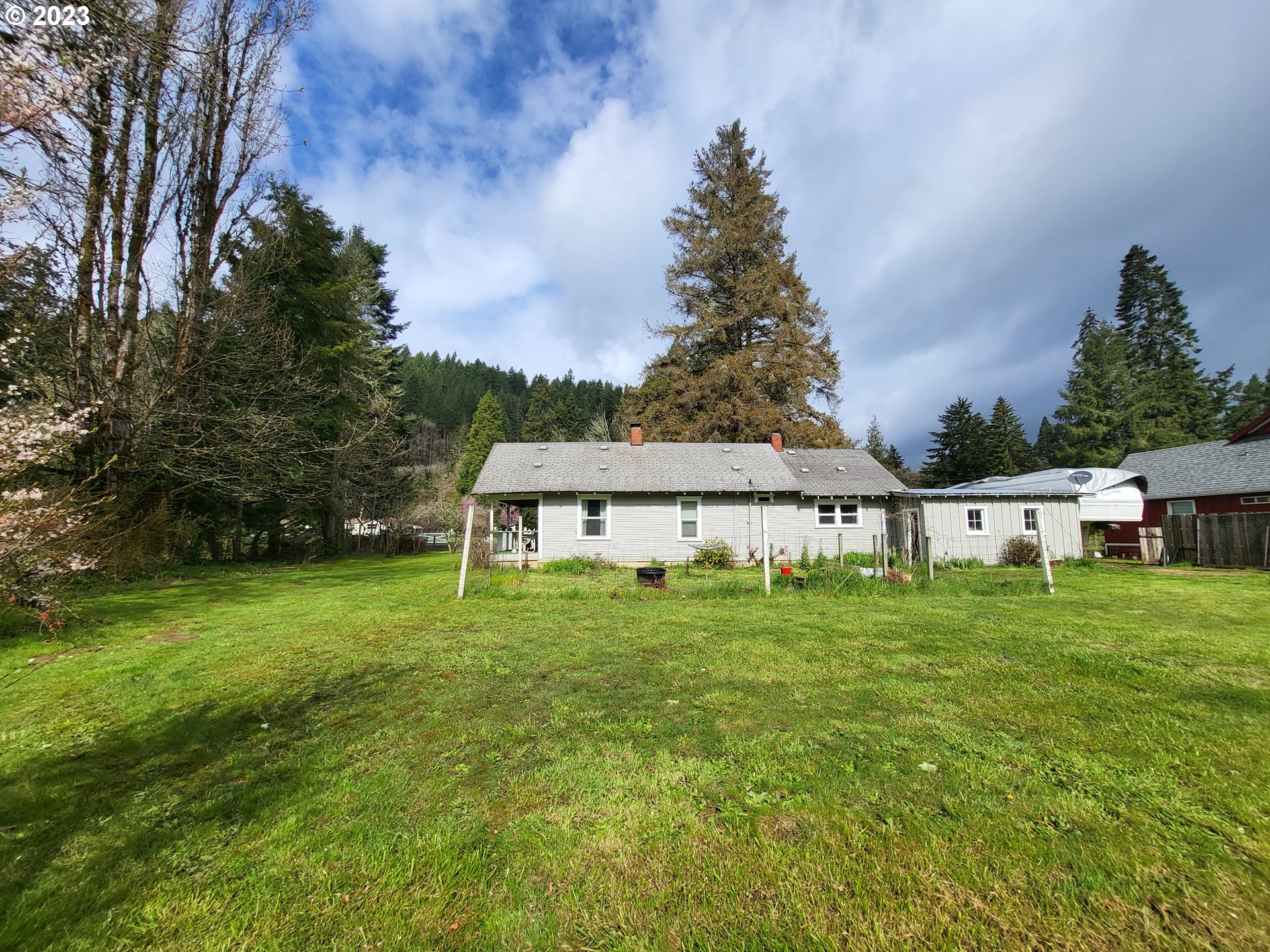 1001 Curtin Road Cottage Grove, OR 97424 - Photo 6 of 24 a house with green field in front of it