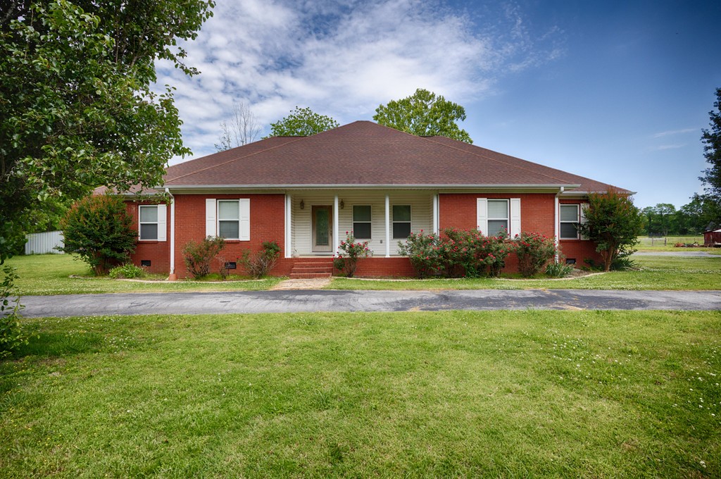 84 Scott Orchard Road Taft, TN 38488 - Photo 4 of 23 a front view of a house with a yard