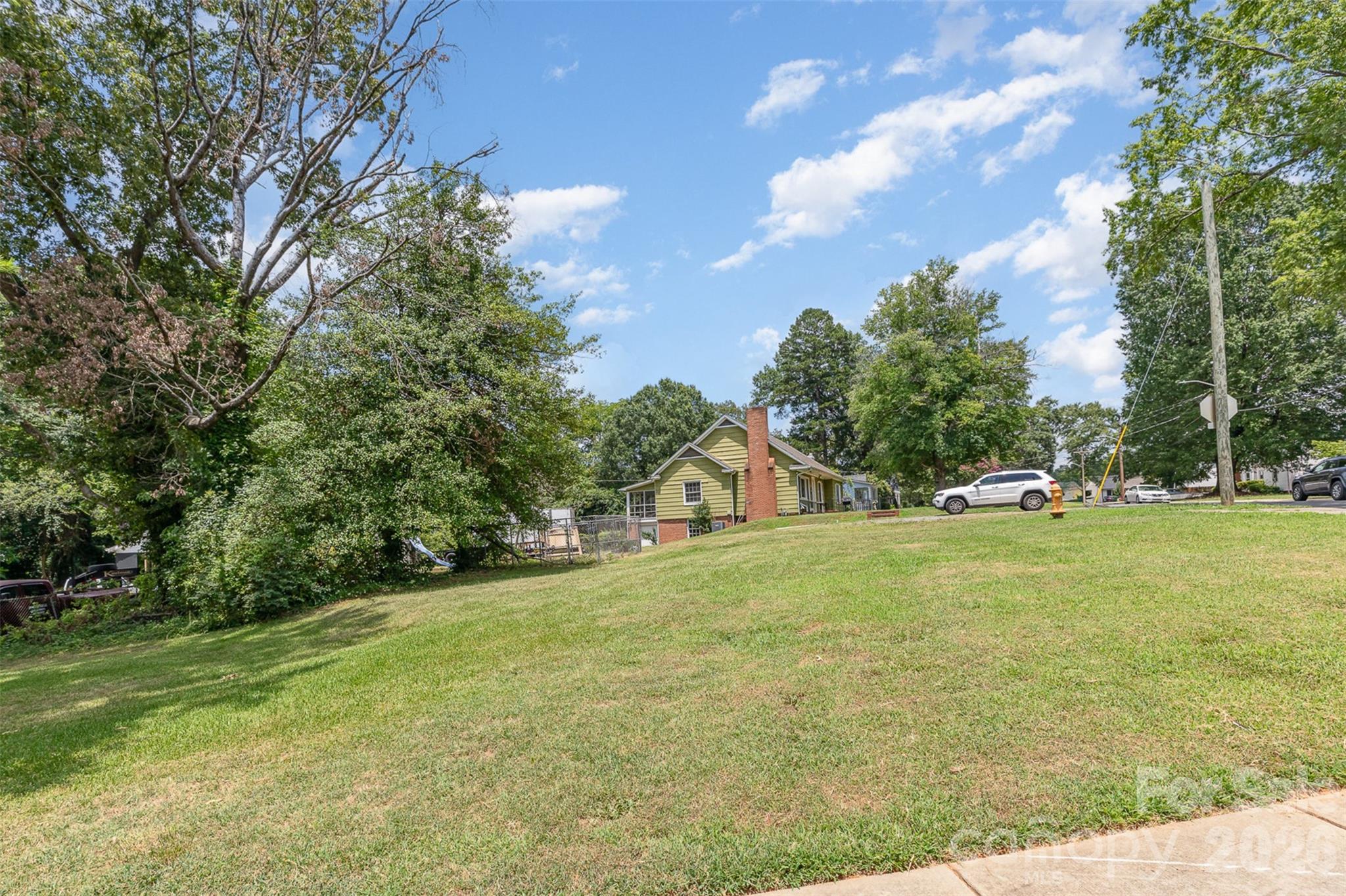1318 Enderly Road Charlotte, NC 28208 - Photo 13 of 33 a front view of a house with a yard and trees
