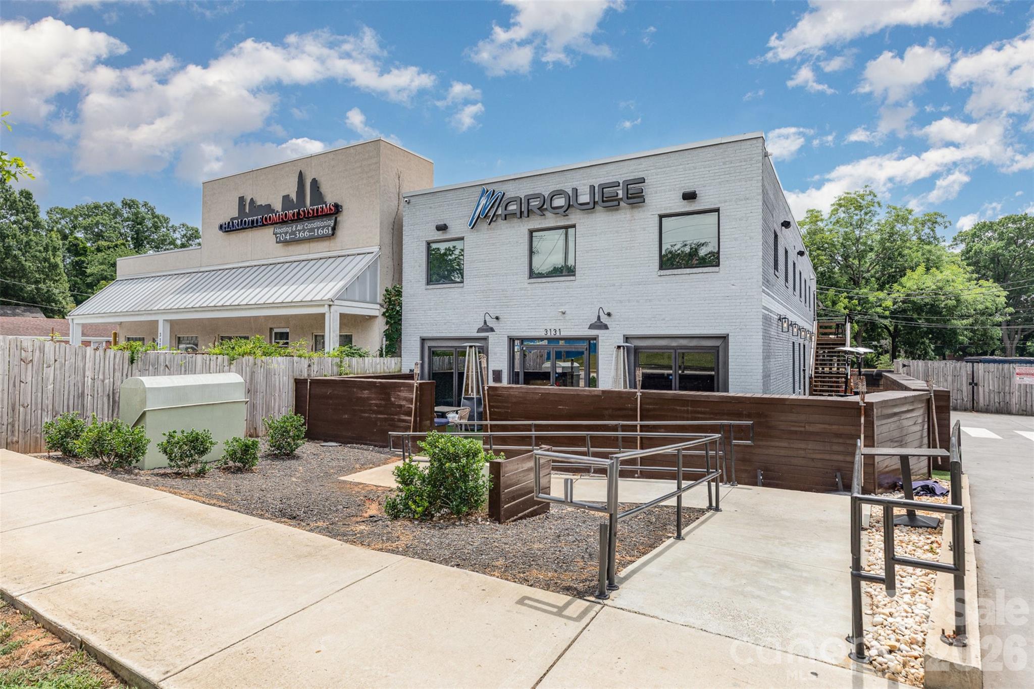 1318 Enderly Road Charlotte, NC 28208 - Photo 16 of 33 a view of a patio with table and chairs potted plants and a large tree