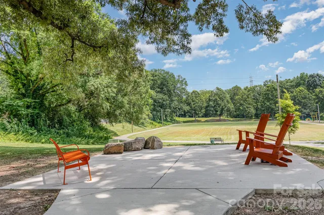 a swimming pool with outdoor seating and yard