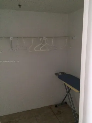 a bedroom with a bed and chair in it