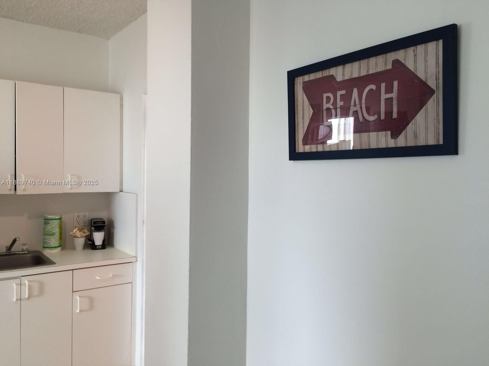 6345 Collins Avenue, Unit 937 Miami Beach, FL 33141 - Photo 24 of 27 a white refrigerator freezer sitting inside of a kitchen