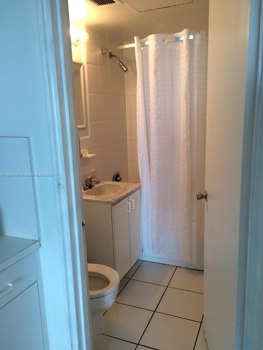 6345 Collins Avenue, Unit 937 Miami Beach, FL 33141 - Photo 26 of 27 a bathroom with a shower and toilet