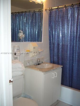 6345 Collins Avenue, Unit 937 Miami Beach, FL 33141 - Photo 5 of 27 a bathroom with a sink a toilet and shower