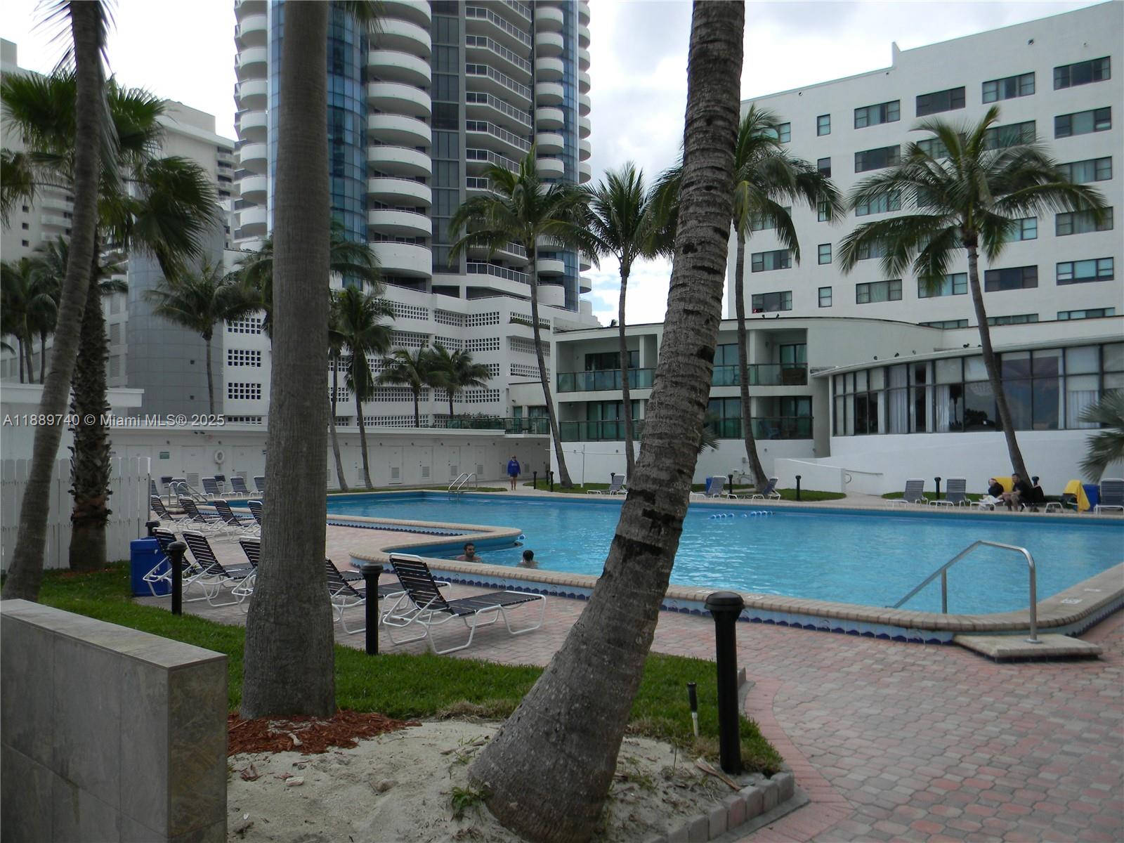 6345 Collins Avenue, Unit 937 Miami Beach, FL 33141 - Photo 10 of 27 a front view of a building with outdoor seating and plants