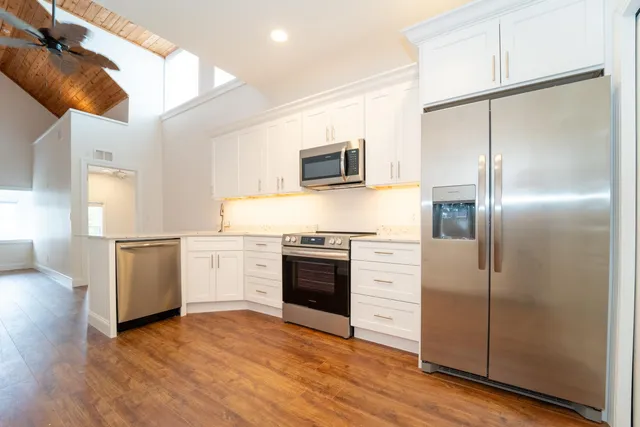 a kitchen with a refrigerator and a stove