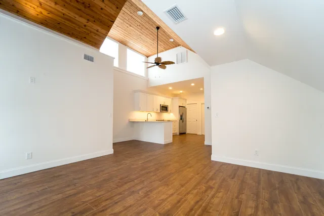 a view of a kitchen with a sink and a wooden floor