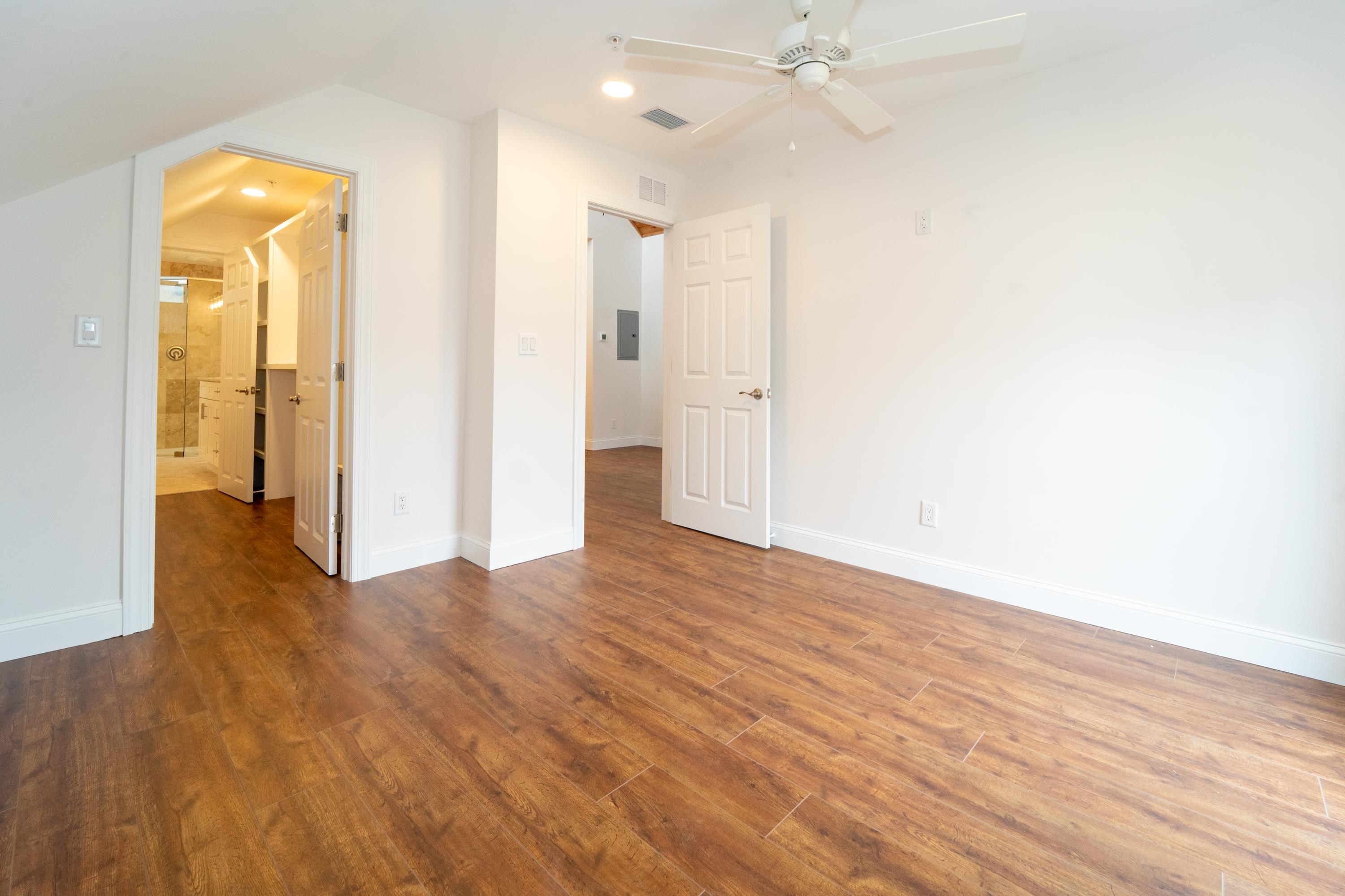 11 Aviles Street, Unit 3A St. Augustine, FL 32084 - Photo 7 of 17 a view of a room with wooden floor and a ceiling fan