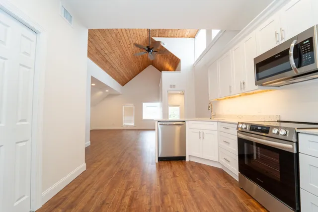 a kitchen with a stove a sink and a microwave