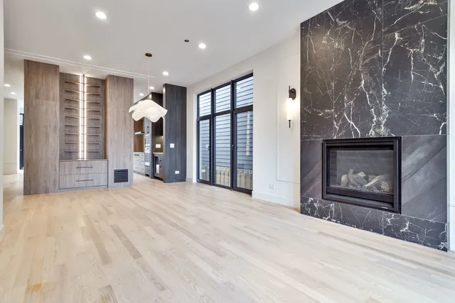 a view of an empty room with a fireplace and a window