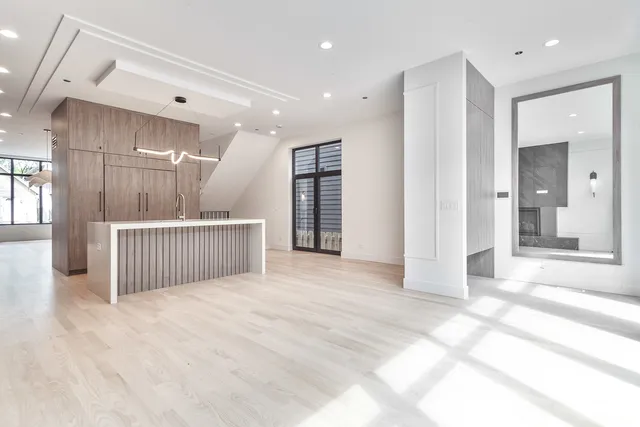 a view of a hallway with wooden floor and windows