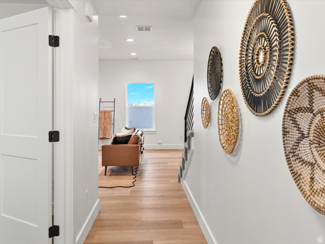 1267 West 2350 South Perry, UT 84302 - Photo 9 of 35 Hallway featuring light wood-finish flooring, recessed ceiling lighting, and crisp white walls