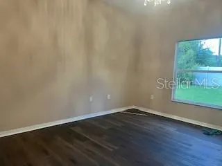 a view of a small space with wooden floor and a window