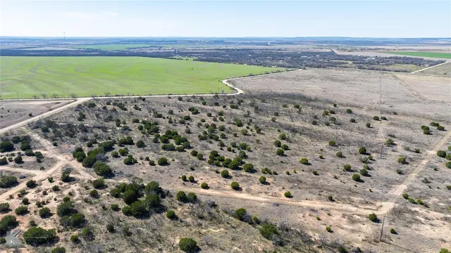a view of a field with an ocean view