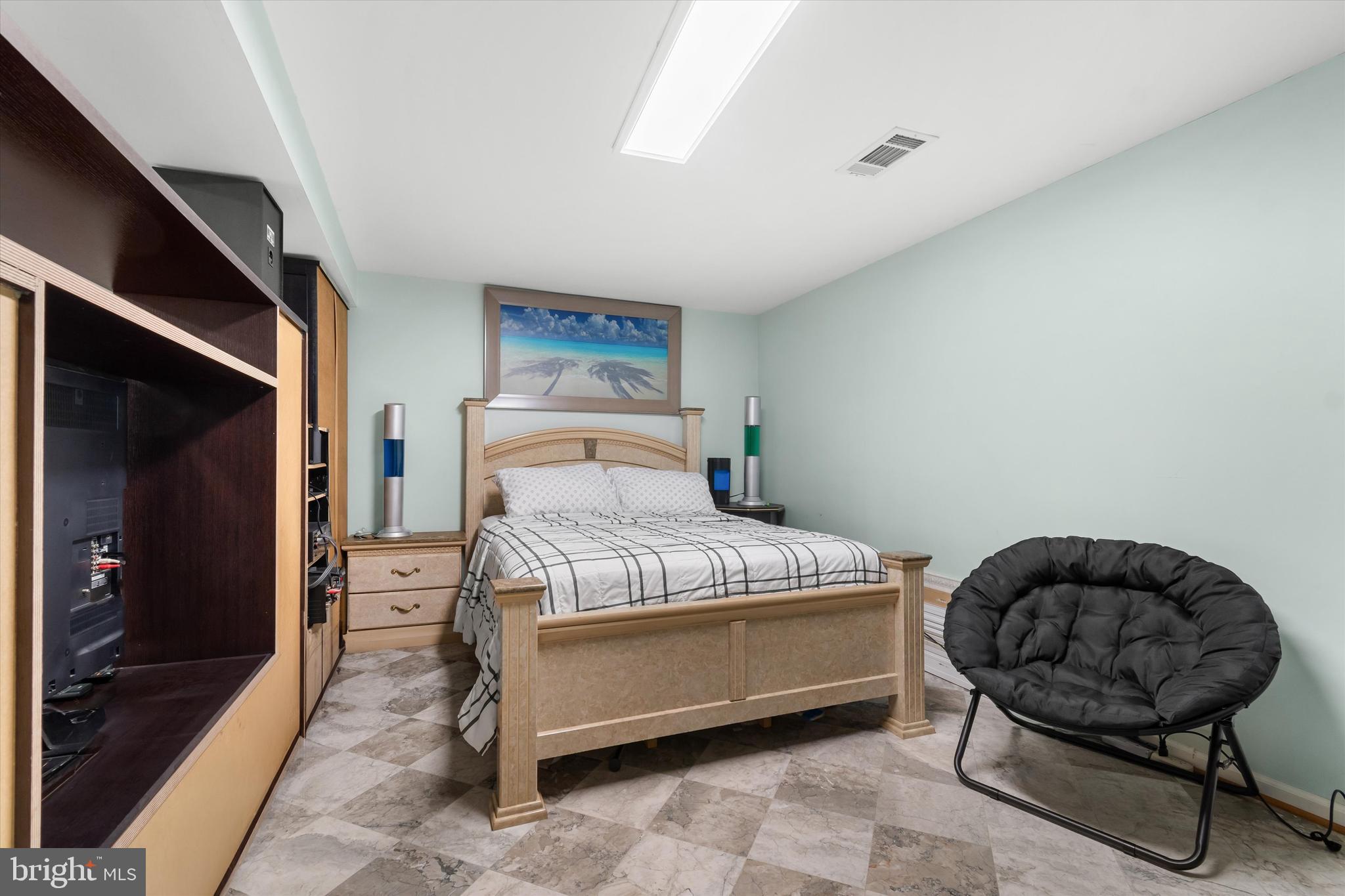 8304 Harland Drive Springfield, VA 22152 - Photo 27 of 39 a bedroom with a bed a mirror and couch