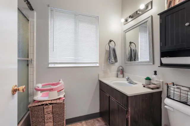 a bathroom with a sink vanity and a mirror