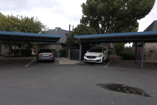 a car parked in parking area next to a road