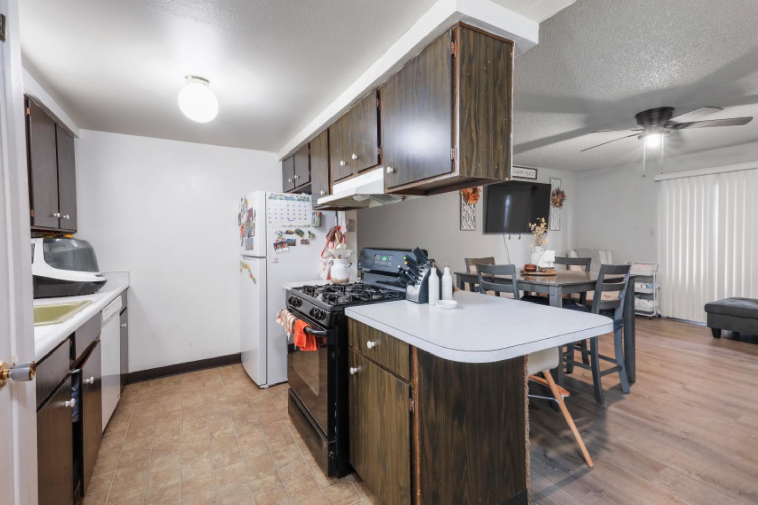 2402 West Turner Road Lodi, CA 95242 - Photo 7 of 14 a kitchen with stainless steel appliances a sink stove and refrigerator