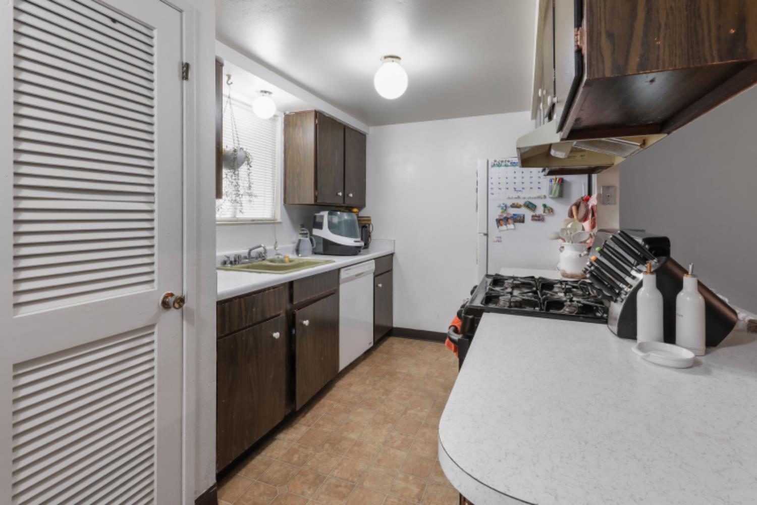 2402 West Turner Road Lodi, CA 95242 - Photo 8 of 14 a kitchen with a stove a sink and a refrigerator