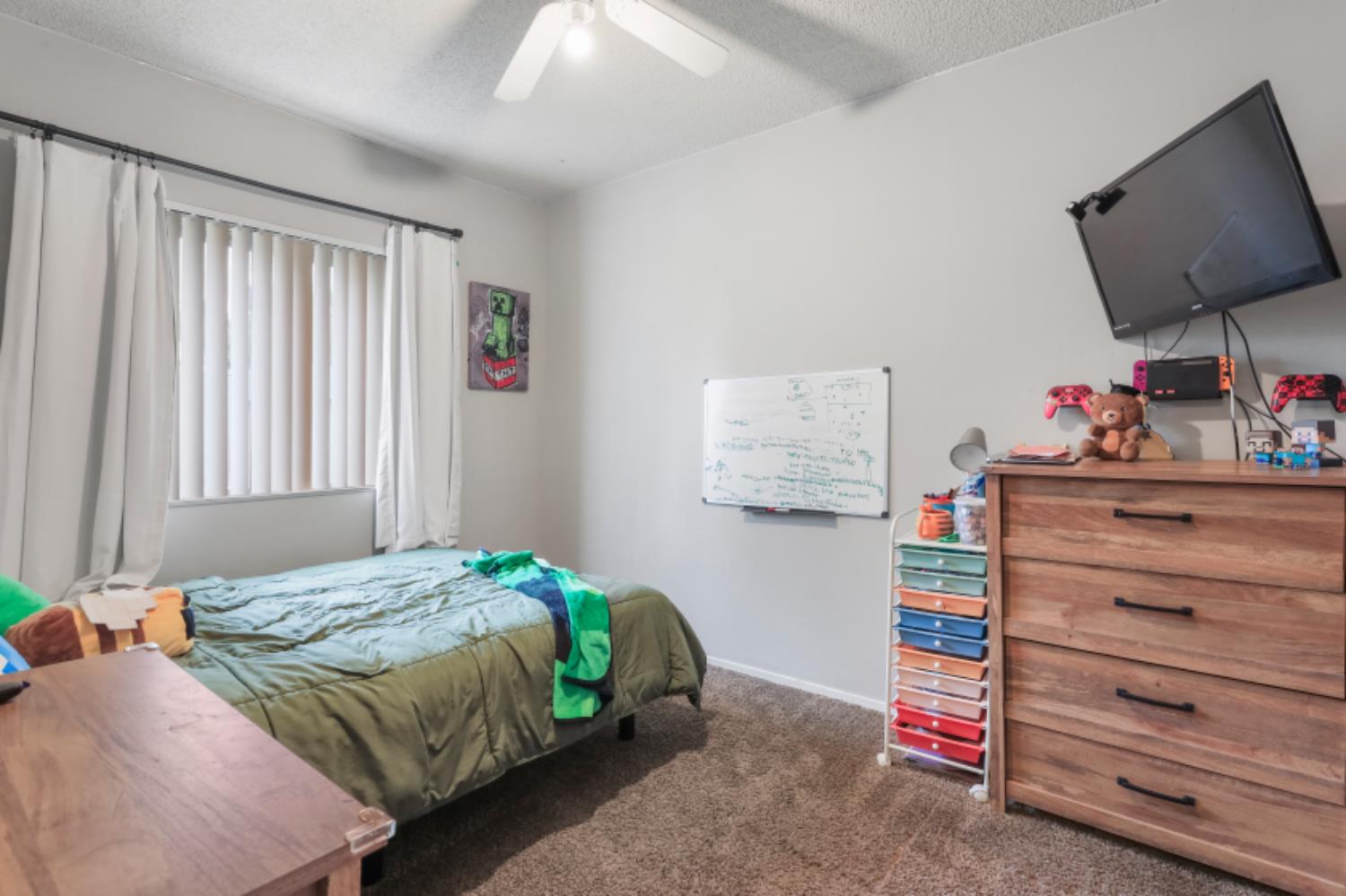 2402 West Turner Road Lodi, CA 95242 - Photo 10 of 14 a bedroom with a bed and a flat tv screen