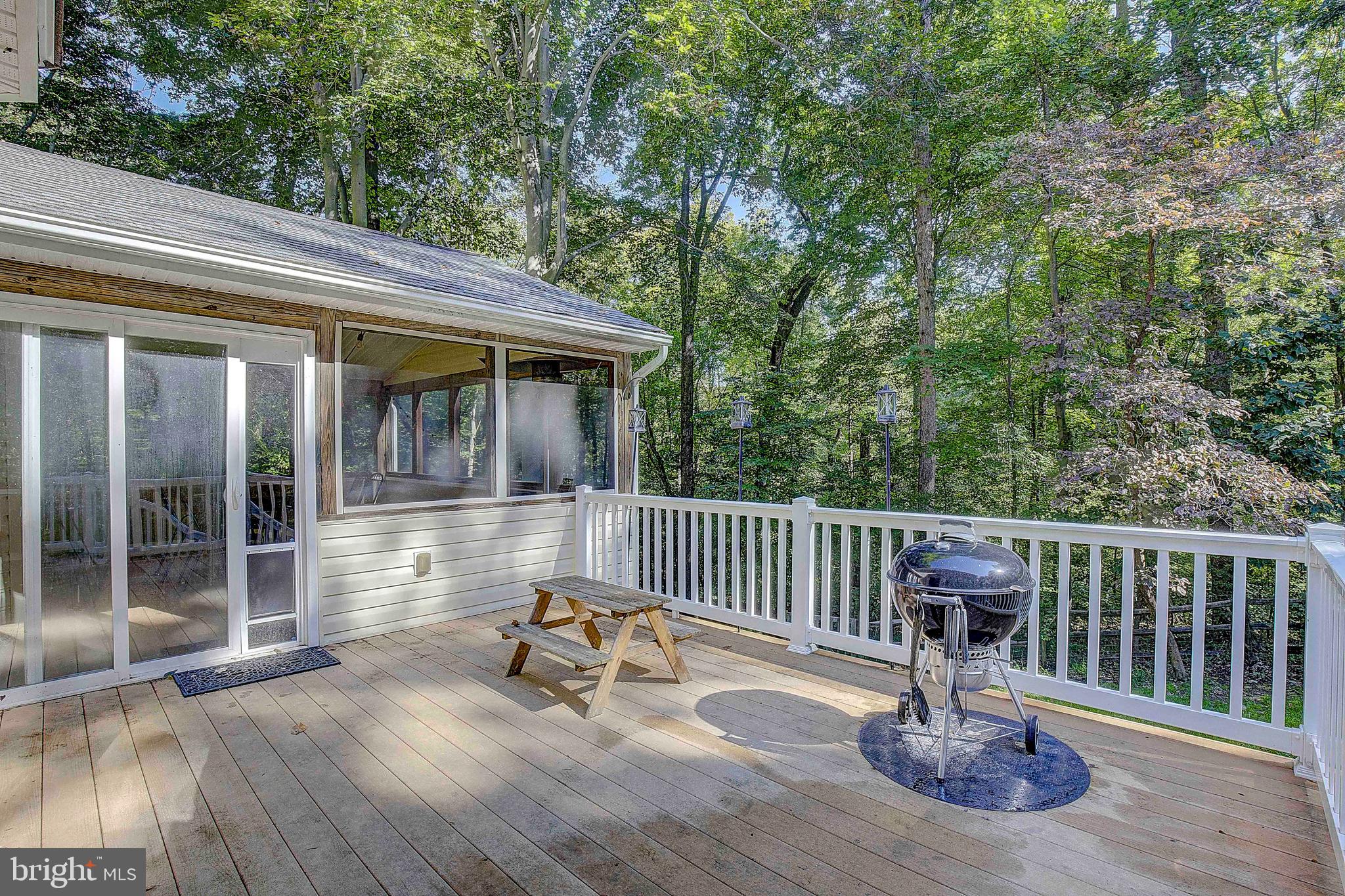 205 Walnut Creek Road Huntingtown, MD 20639 - Photo 45 of 48 a view of a patio with a table chairs and a small yard