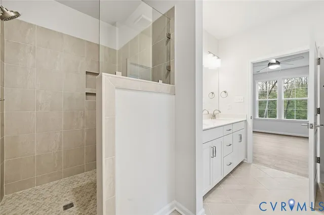 a bathroom with a granite countertop sink mirror and shower