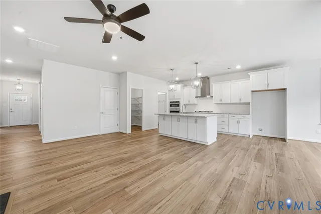 a view of a kitchen with wooden floor and a kitchen