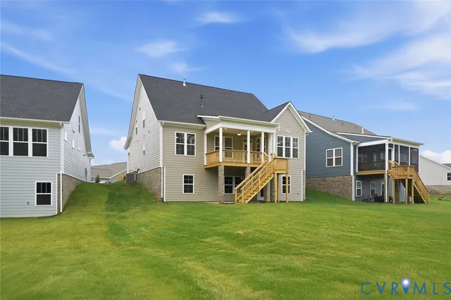a view of a house with a big yard and large trees