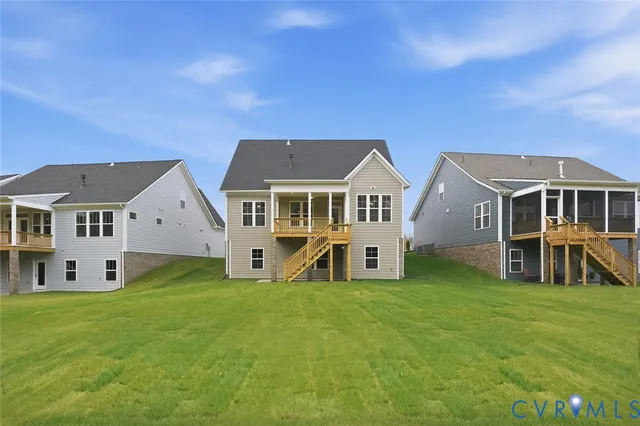 a view of a house with a big yard and large trees