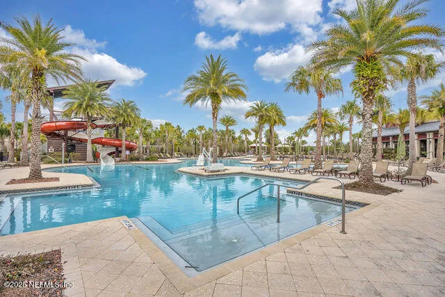 a view of a swimming pool with lounge chairs