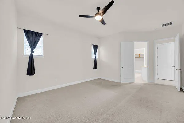 an empty room with a empty space and windows