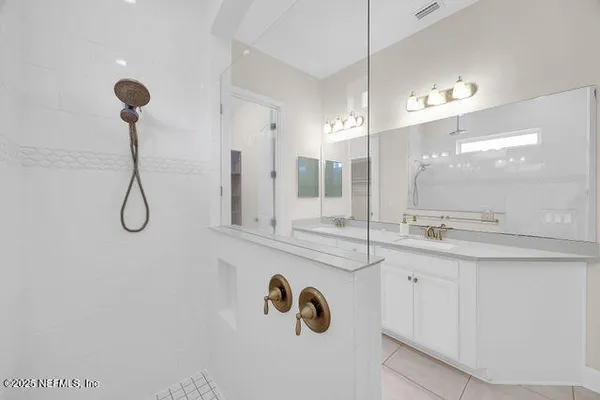 a bathroom with a glass shower door and a toilet