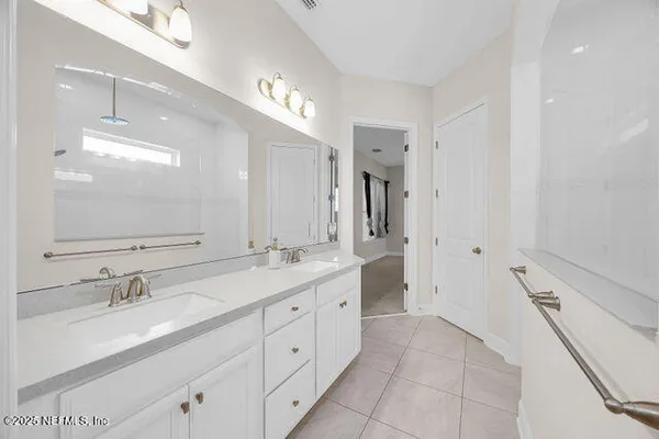 an empty room with ceiling fan and window